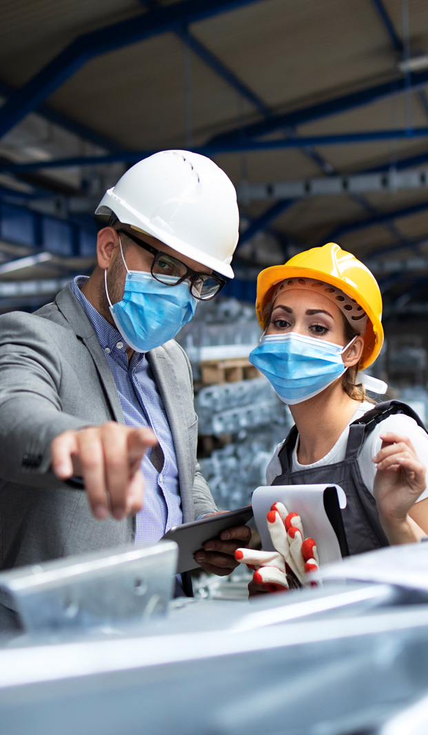 Handsome business man engineer in hard hat in a building