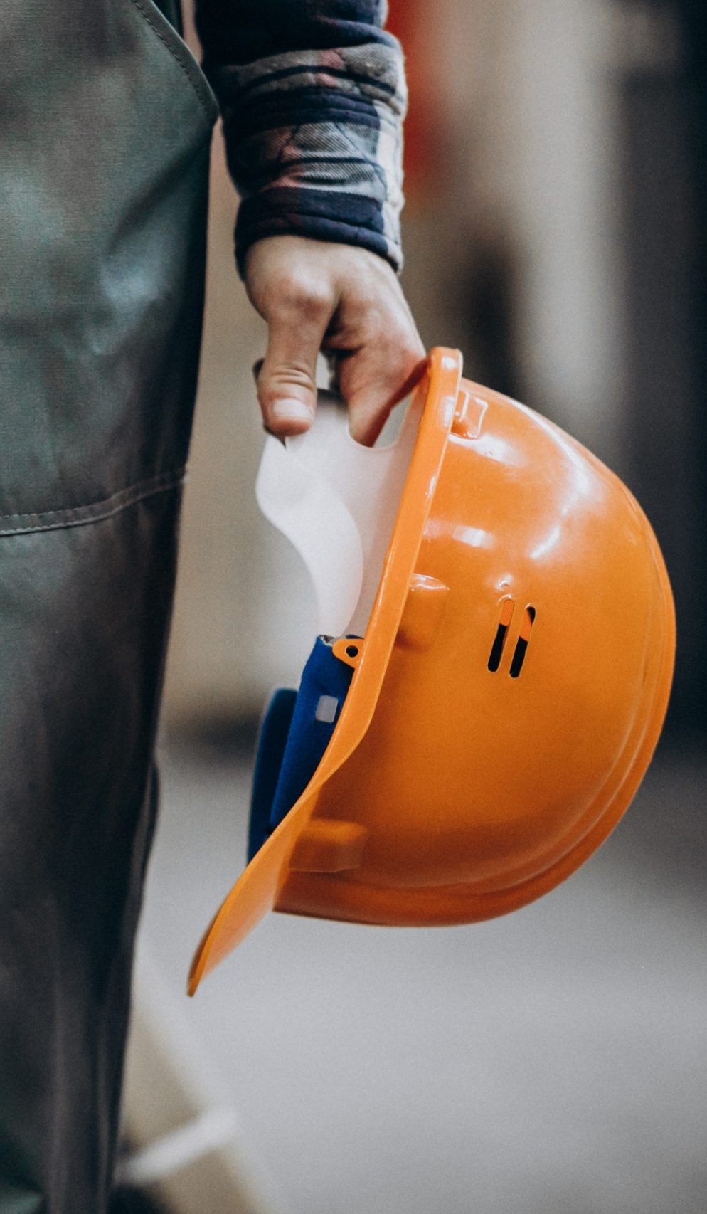 Young male handyman with safety earphones